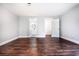 Spacious bedroom with dark hardwood floors, with a bathroom and closet in the distance at 3978 Oglesby Rd, Powder Springs, GA 30127