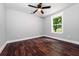 Cozy bedroom with hardwood floors, a ceiling fan and a window showing a tree at 3978 Oglesby Rd, Powder Springs, GA 30127