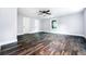 Spacious bedroom with dark floors, ceiling fan, and ample natural light at 3978 Oglesby Rd, Powder Springs, GA 30127