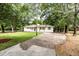 Charming home featuring a well-manicured lawn and a long driveway, framed by mature trees at 3978 Oglesby Rd, Powder Springs, GA 30127