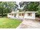 Charming home featuring fresh paint, new shutters and a well maintained lawn at 3978 Oglesby Rd, Powder Springs, GA 30127