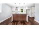 Bright kitchen featuring a stylish island, modern lighting, stainless vent hood, and sleek cabinets at 3978 Oglesby Rd, Powder Springs, GA 30127