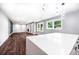 Open-concept living room with dark wood floors, stylish lighting, and bright windows at 3978 Oglesby Rd, Powder Springs, GA 30127