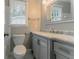 Bathroom features white cabinets, shower with tub, and a window for natural light at 4248 Wellington Hills Ln, Snellville, GA 30039