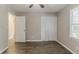 Bedroom featuring closet, light wood look floors, and large window at 4248 Wellington Hills Ln, Snellville, GA 30039