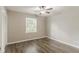 Bedroom features a window for natural light, plus light wood look floors at 4248 Wellington Hills Ln, Snellville, GA 30039