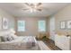 Cozy bedroom featuring two windows, a ceiling fan, and wood-look flooring at 4248 Wellington Hills Ln, Snellville, GA 30039