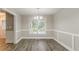 Dining room featuring wood floors and wainscoting at 4248 Wellington Hills Ln, Snellville, GA 30039