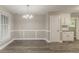 Dining room featuring wood floors, wainscoting, and neutral paint at 4248 Wellington Hills Ln, Snellville, GA 30039