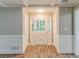 Front entryway with white door, wood floors, and white wainscoting at 4248 Wellington Hills Ln, Snellville, GA 30039