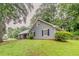 Side view of home featuring lush green lawn and mature trees at 4248 Wellington Hills Ln, Snellville, GA 30039