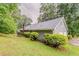 Well-maintained home exterior with lush green lawn and mature trees at 4248 Wellington Hills Ln, Snellville, GA 30039