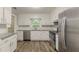 Bright kitchen features stainless appliances, granite counters, subway tile backsplash, and wood-look floors at 4248 Wellington Hills Ln, Snellville, GA 30039