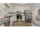 Updated kitchen showcasing stainless steel appliances and granite countertops at 4248 Wellington Hills Ln, Snellville, GA 30039