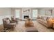 Staged living room featuring a fireplace and ample seating at 4248 Wellington Hills Ln, Snellville, GA 30039