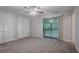 Bedroom with neutral walls, ceiling fan, closet and sliding glass door to balcony at 220 Harwell Nw Rd, Atlanta, GA 30331