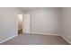 Spacious bedroom with neutral walls, carpet, and an open door leading to another room at 220 Harwell Nw Rd, Atlanta, GA 30331
