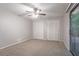 Bedroom featuring neutral walls, ceiling fan, balcony access, and closet space at 220 Harwell Nw Rd, Atlanta, GA 30331