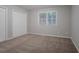 This cozy bedroom features neutral carpeting, a double closet, and a window letting in natural light at 220 Harwell Nw Rd, Atlanta, GA 30331