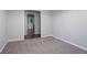 Spacious bedroom with neutral walls, carpet, and a doorway leading to another room at 220 Harwell Nw Rd, Atlanta, GA 30331