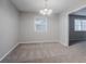 Open dining area with carpet flooring and a chandelier with natural light coming in from a window at 220 Harwell Nw Rd, Atlanta, GA 30331