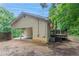 Back exterior of home featuring wooden steps leading up to house, an attached carport, and grassy front yard at 220 Harwell Nw Rd, Atlanta, GA 30331