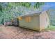 Back exterior of home with wooden deck. Siding is light yellow. Surrounding area is wooded at 220 Harwell Nw Rd, Atlanta, GA 30331