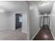 Inviting hallway with hardwood floors, neutral paint, and ample lighting at 220 Harwell Nw Rd, Atlanta, GA 30331