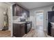 Open kitchen with dark cabinets, neutral countertops and stainless appliances at 220 Harwell Nw Rd, Atlanta, GA 30331
