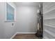 This laundry area has wood flooring, a window, and shelving, as well as the water heater at 220 Harwell Nw Rd, Atlanta, GA 30331