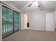 Bright main bedroom with neutral walls, ceiling fan, closets, and balcony access at 220 Harwell Nw Rd, Atlanta, GA 30331