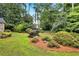 Lush backyard featuring mature landscaping, pine straw, and a variety of shrubs and plantings at 2786 Olde Gate Ct, Snellville, GA 30078