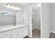 Ensuite bathroom featuring bright vanity lighting, a closet, and tile flooring at 2786 Olde Gate Ct, Snellville, GA 30078