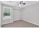 Cozy bedroom featuring neutral walls, carpet flooring and a ceiling fan with integrated lighting at 2786 Olde Gate Ct, Snellville, GA 30078
