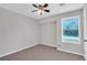 Bedroom showcasing a fan and a window, featuring plush carpeting and a neutral color scheme at 2786 Olde Gate Ct, Snellville, GA 30078