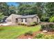 View of the home's exterior, enhanced by a landscaped yard with mature trees and native plants at 2786 Olde Gate Ct, Snellville, GA 30078