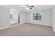 Generous main bedroom featuring neutral carpet, fan, window and a view of the ensuite bathroom at 2786 Olde Gate Ct, Snellville, GA 30078