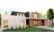 Contemporary home boasts a striking facade with a blend of brick, wood, and dark accents at 104 Accolade Pkwy, Mcdonough, GA 30252