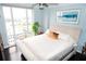 Bright bedroom featuring a large window with city views, a comfortable bed, and stylish decor at 3475 Oak Valley Ne Rd # 980, Atlanta, GA 30326