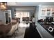 Open-concept living room features dark hardwood floors and bright, sunlit windows at 3475 Oak Valley Ne Rd # 980, Atlanta, GA 30326