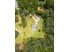 Aerial view of a home nestled among mature trees, featuring expansive green space and a private driveway at 4841 Partee Trl, Social Circle, GA 30025