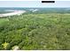 An aerial view of a lush green landscape and dense forest, offering a private and serene setting at 4841 Partee Trl, Social Circle, GA 30025