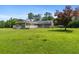 Expansive backyard featuring an outdoor living area and mature trees at 4841 Partee Trl, Social Circle, GA 30025