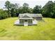 Aerial view of a home featuring a spacious screened-in porch and an expansive backyard at 4841 Partee Trl, Social Circle, GA 30025