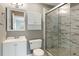 Bathroom featuring a modern vanity, tiled walls, and a glass-enclosed shower, creating a clean and stylish space at 4841 Partee Trl, Social Circle, GA 30025