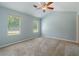 Cozy bedroom with vaulted ceiling, fan, and natural light from two windows at 4841 Partee Trl, Social Circle, GA 30025