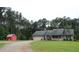 Traditional home with a two-car garage and shed, nestled on a large lot with mature trees at 4841 Partee Trl, Social Circle, GA 30025