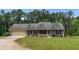 Charming single-story home with a well-maintained lawn and an attached two-car garage at 4841 Partee Trl, Social Circle, GA 30025
