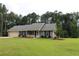Well-maintained lawn and landscaping enhance this charming home's curb appeal with garage and symmetrical windows at 4841 Partee Trl, Social Circle, GA 30025