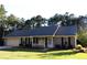 Charming single story home with manicured lawn, attached garage, and inviting front porch at 4841 Partee Trl, Social Circle, GA 30025
